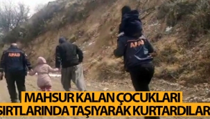 Mahsur kalan çocukları sırtlarında taşıyarak kurtardılar