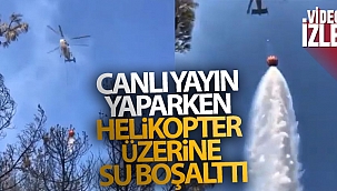 Canlı yayın yaparken helikopter üzerine su boşalttı